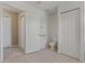 Bright bathroom featuring tile flooring, a toilet, and a closet with white doors at 20115 Nob Oak Ave, Tampa, FL 33647
