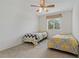 Bedroom featuring two twin beds, carpet floors, a ceiling fan, and a window with blinds at 20115 Nob Oak Ave, Tampa, FL 33647