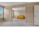 Cozy bonus room with neutral walls and carpet flooring, featuring a bright yellow couch at 20115 Nob Oak Ave, Tampa, FL 33647