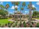 A beautiful clubhouse surrounded by palm trees and lush landscaping, with a flagpole and brick pathway at 20115 Nob Oak Ave, Tampa, FL 33647
