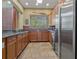 A well-appointed kitchen featuring ample counter space, stainless steel appliances, and warm wooden cabinetry at 20115 Nob Oak Ave, Tampa, FL 33647
