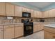 Kitchen features a gas range, microwave, ample counter space, and tiled backsplash at 20115 Nob Oak Ave, Tampa, FL 33647