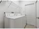 Practical laundry room equipped with modern washer and dryer units and shelving at 20115 Nob Oak Ave, Tampa, FL 33647