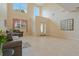 The bright living room features a soaring ceiling, neutral decor, and views of the front yard at 20115 Nob Oak Ave, Tampa, FL 33647