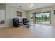 Bright living room with tile flooring, stylish seating, and sliding glass doors to the pool area at 20115 Nob Oak Ave, Tampa, FL 33647