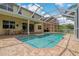 The screened-in pool is surrounded by brick pavers, offering a relaxing outdoor space at 20115 Nob Oak Ave, Tampa, FL 33647