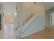 Carpeted staircase with white railing leading to the upper level of the home at 20115 Nob Oak Ave, Tampa, FL 33647
