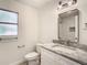Modern bathroom with granite counters, a toilet, and updated fixtures at 2101 E Ellicott St, Tampa, FL 33610