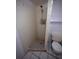 Compact bathroom featuring a tiled shower, toilet, and essential fixtures at 2101 E Ellicott St, Tampa, FL 33610