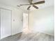 Clean, spacious bedroom featuring wood-look flooring, a ceiling fan, and ample closet space at 2101 E Ellicott St, Tampa, FL 33610