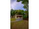 Exterior view of a residential property with mature trees at 2101 E Ellicott St, Tampa, FL 33610