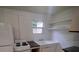 Cozy kitchen showcasing a stove, vintage-style sink, granite countertop, and essential appliances at 2101 E Ellicott St, Tampa, FL 33610