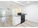 Modern kitchen boasts an island with granite countertop and stainless steel appliances at 2101 E Ellicott St, Tampa, FL 33610