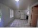 Bright kitchen featuring tile floors, white appliances, and ample natural light from a window at 2101 E Ellicott St, Tampa, FL 33610