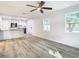 Open-concept living area with modern flooring, seamlessly connecting to the kitchen at 2101 E Ellicott St, Tampa, FL 33610