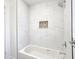 Elegant tiled shower with a mosaic niche over a tub at 2101 E Ellicott St, Tampa, FL 33610