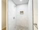 Elegant tiled shower with a rainfall showerhead and mosaic accent niche at 2101 E Ellicott St, Tampa, FL 33610