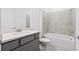Cozy bathroom offers a tub with nice tile work and a gray vanity at 2743 Winding Creek Trl, North Port, FL 34289