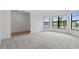 This bonus room features big windows and carpeted and hardwood flooring at 2743 Winding Creek Trl, North Port, FL 34289