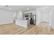 Modern kitchen features a large island with quartz countertops and stainless steel appliances at 2743 Winding Creek Trl, North Port, FL 34289