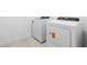 This laundry room features tile floors and a new dryer and washing machine at 2743 Winding Creek Trl, North Port, FL 34289