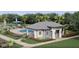 Community clubhouse with a pool and ample lounging space at 2743 Winding Creek Trl, North Port, FL 34289