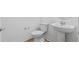 This powder room includes a simple vanity and toilet at 2743 Winding Creek Trl, North Port, FL 34289