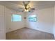 An empty bedroom with natural light, carpet floors, a ceiling fan, and a wall shelf at 3234 37Th N St, St Petersburg, FL 33713