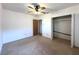 Empty bedroom with neutral carpet, ceiling fan, and a closet, perfect for a personalized touch at 3234 37Th N St, St Petersburg, FL 33713