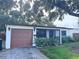Charming single-story home featuring a one car garage and mature landscaping in front at 3234 37Th N St, St Petersburg, FL 33713