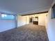 Living room with carpeted floors, a ceiling fan, and open access to the kitchen at 3234 37Th N St, St Petersburg, FL 33713