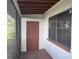 View of the screened-in porch, with painted brick and a doorway leading to a storage area at 3234 37Th N St, St Petersburg, FL 33713