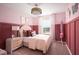 Charming pink bedroom with paneling, a plush bed, and natural light from the window at 37078 Sagemoor Dr, Zephyrhills, FL 33541
