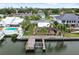 Waterfront home features private boat dock and lift with a screened pool, perfect for relaxing outdoors at 3921 E Eden Roc Cir, Tampa, FL 33634