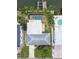 Aerial view of the property featuring a pool, a dock, and mature trees at 3921 E Eden Roc Cir, Tampa, FL 33634