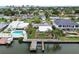 Waterfront home features private boat dock and lift with a screened pool, perfect for relaxing outdoors at 3921 E Eden Roc Cir, Tampa, FL 33634