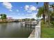 Picturesque waterfront property featuring a private dock, canal access, and lush greenery at 3921 E Eden Roc Cir, Tampa, FL 33634