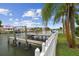 A private dock provides direct access to the water, complemented by lush landscaping and secure fencing at 3921 E Eden Roc Cir, Tampa, FL 33634