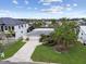 Aerial view of a well-maintained home with lush landscaping and a long driveway leading to the garage at 3921 E Eden Roc Cir, Tampa, FL 33634