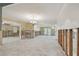 An empty room ready to be designed featuring tile floors and exposed framing and the light from a ceiling fixture at 3921 E Eden Roc Cir, Tampa, FL 33634