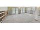 Spacious room awaiting remodel featuring tile floors, recessed lighting, and access to the pool area at 3921 E Eden Roc Cir, Tampa, FL 33634