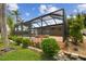 Screened in pool with a built-in spa and well-manicured landscaping enhances this backyard's appeal at 3921 E Eden Roc Cir, Tampa, FL 33634