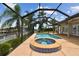 Screened-in pool with a connected jacuzzi, surrounded by a spacious deck, provides a private oasis at 3921 E Eden Roc Cir, Tampa, FL 33634