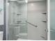 Accessible bathroom with a glass enclosed shower, grab bars, and built-in shelving at 4104 Northmeadow Cir # 4104, Tampa, FL 33618