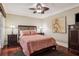 Cozy bedroom with a ceiling fan, hardwood floors, and traditional furnishings at 4104 Northmeadow Cir # 4104, Tampa, FL 33618