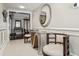 Hallway with decorative mirror, decorative table and chairs plus view into living area at 4104 Northmeadow Cir # 4104, Tampa, FL 33618