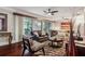 Open living room with hardwood floors, ceiling fan, and sliding glass doors to the outdoor area at 4104 Northmeadow Cir # 4104, Tampa, FL 33618