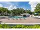 View of outdoor swimming pool area with a building, lounge chairs, and tables at 4104 Northmeadow Cir # 4104, Tampa, FL 33618