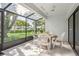 View of the tiled screened porch with furniture overlooking a grassy yard at 4104 Northmeadow Cir # 4104, Tampa, FL 33618