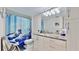 Well-maintained bathroom with a granite countertop, bright lighting, and a decorative shower curtain at 4900 Brittany S Dr # 1011, St Petersburg, FL 33715